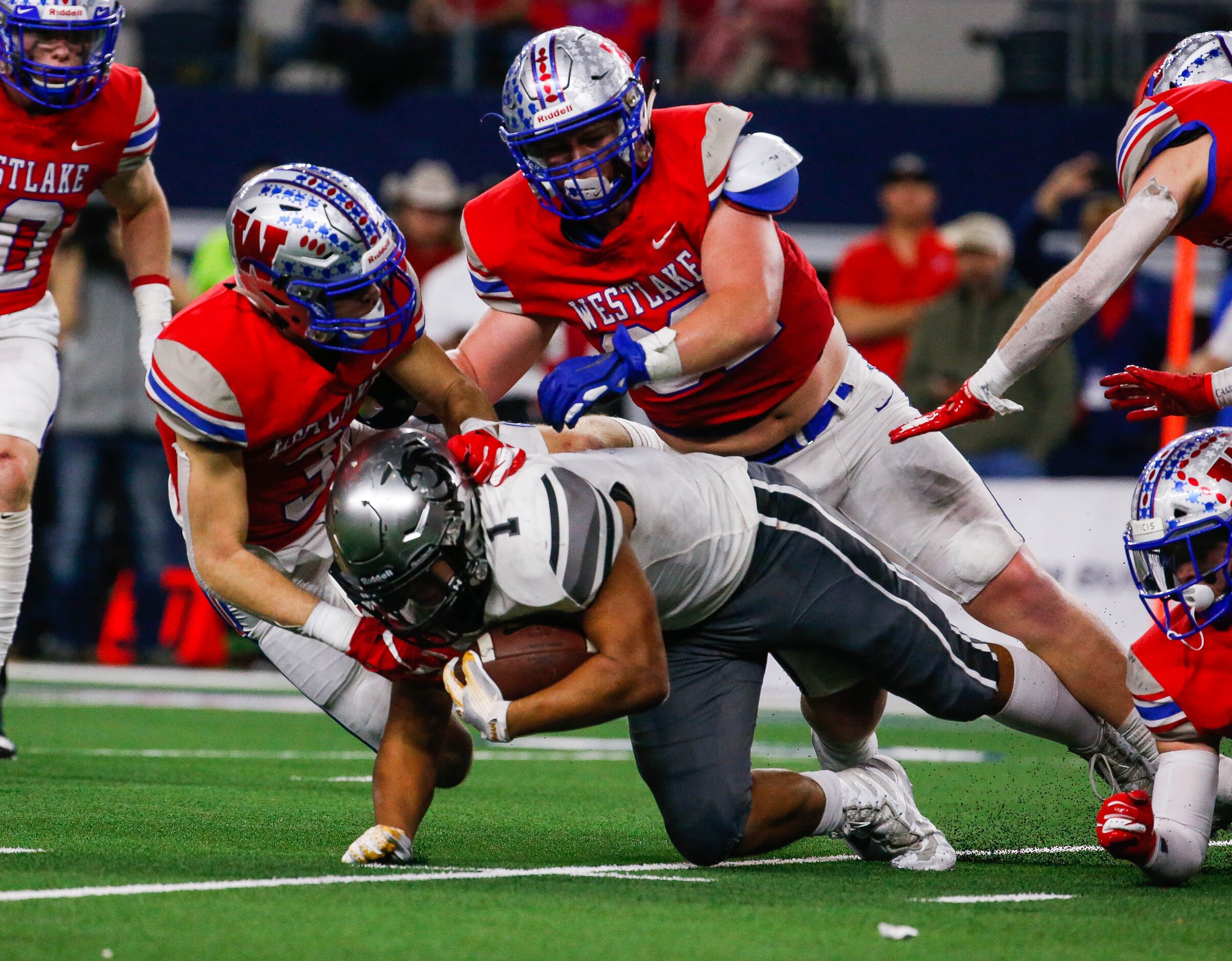 Denton Guyer's Kaedric Cobbs	(1) is tackled by Westlake's defense in the third quarter of a...