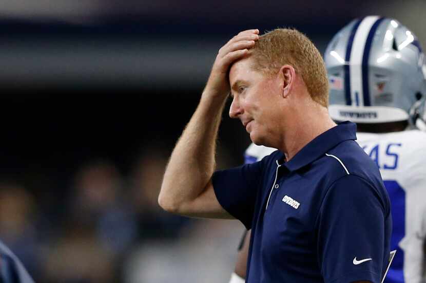 Dallas Cowboys head coach Jason Garrett rubs his head after the defense was called for pass...