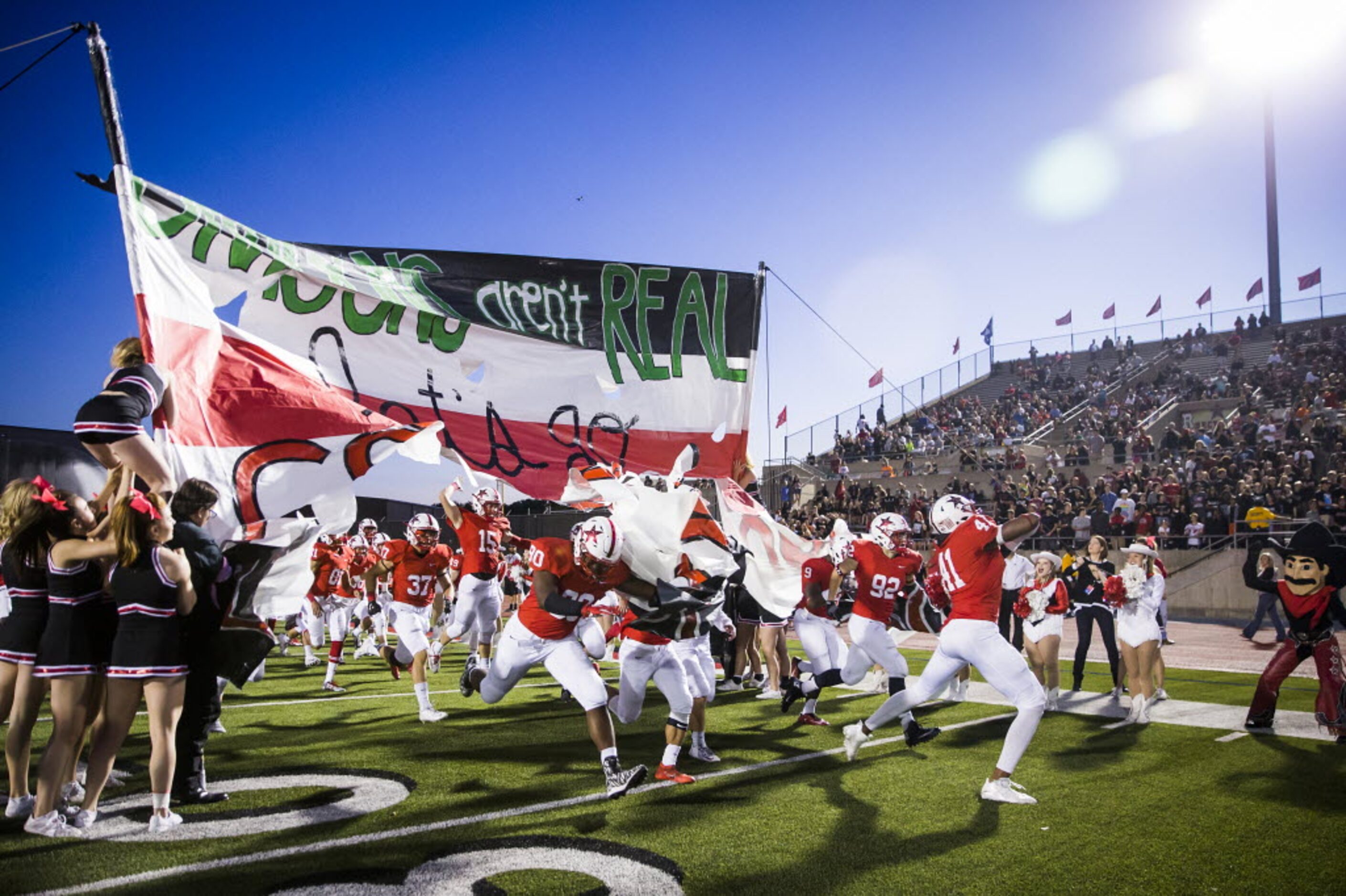 Coppell players take the field to face Southlake Carroll in a high school football game at...