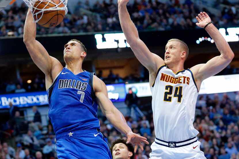 FILE - Dallas Mavericks forward Dwight Powell (7) dunks the ball past Denver Nuggets forward...