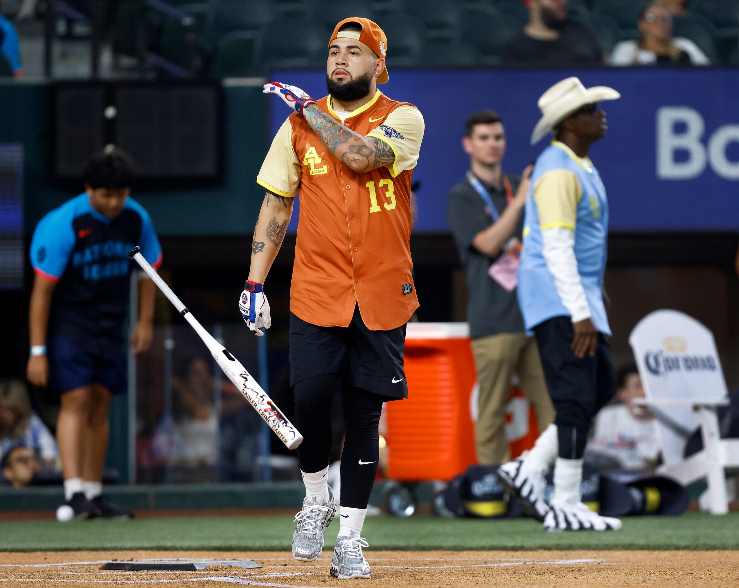 American League batter Foreign Teck tosses his bat after stroking a first inning homer...