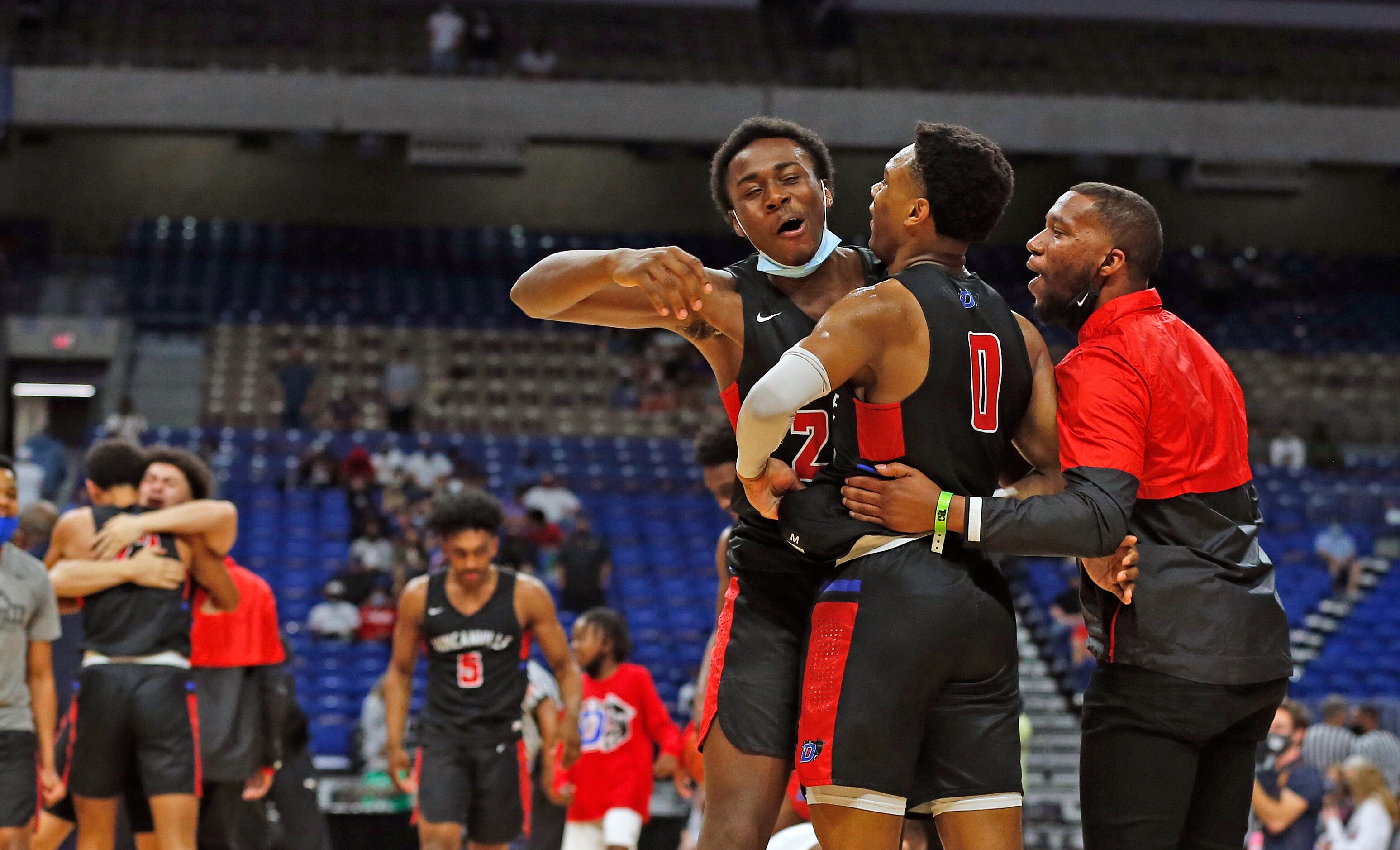 Duncanville Zhuric Phelps #0 is hugged by DeCannon Wickware and staff at the end of the...