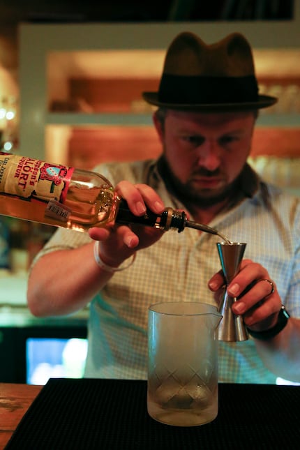 Bartender Jason Pollard mixes the River Runs Backwards cocktail, which utilizes Malort, a...