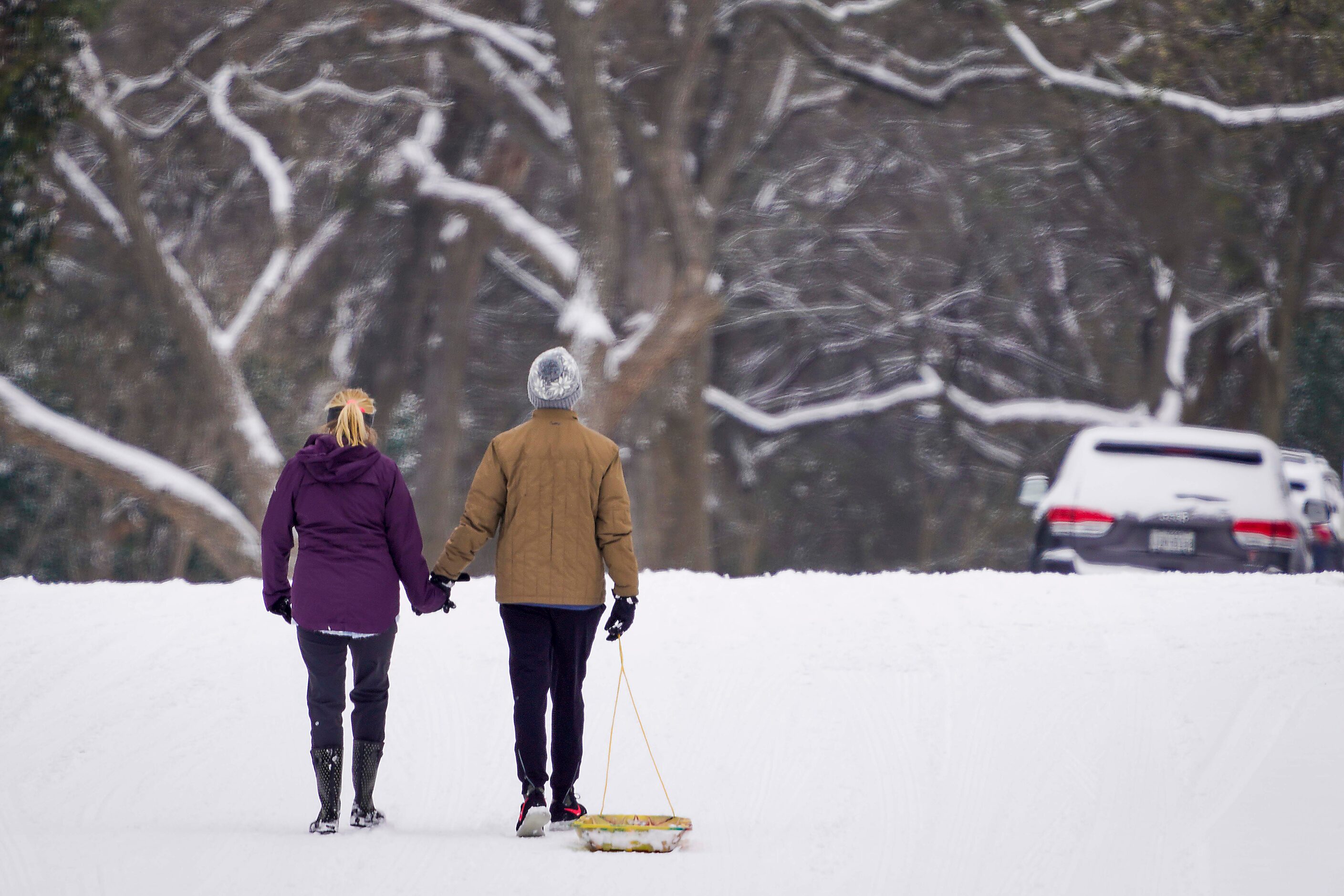 Josh and Amy Moore hold hands as the walk along the street alongside Prairie Creek Park...