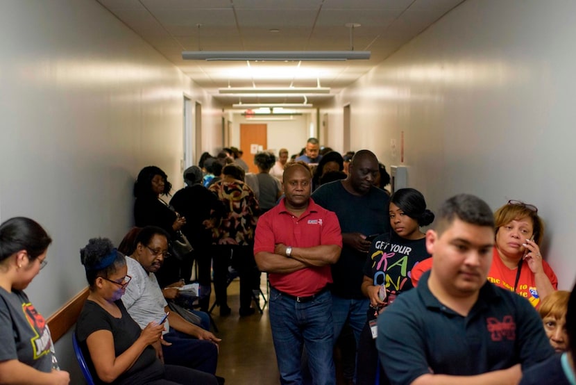 Voters line up at a polling station to cast their ballots during the presidential primary in...