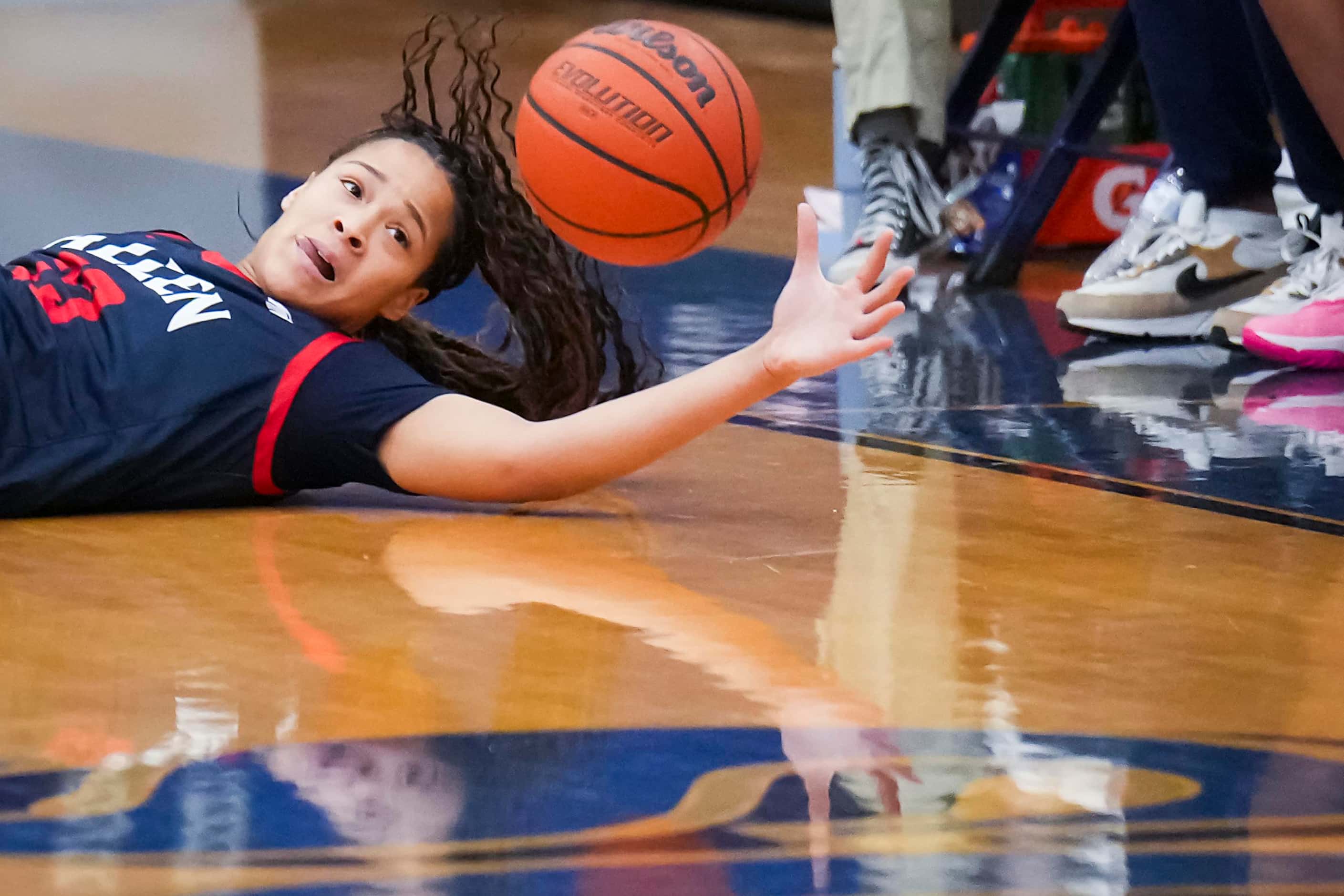 Allen’s Aryn Roberts (23) tumbles chasing a loose ball during the first half of a District...