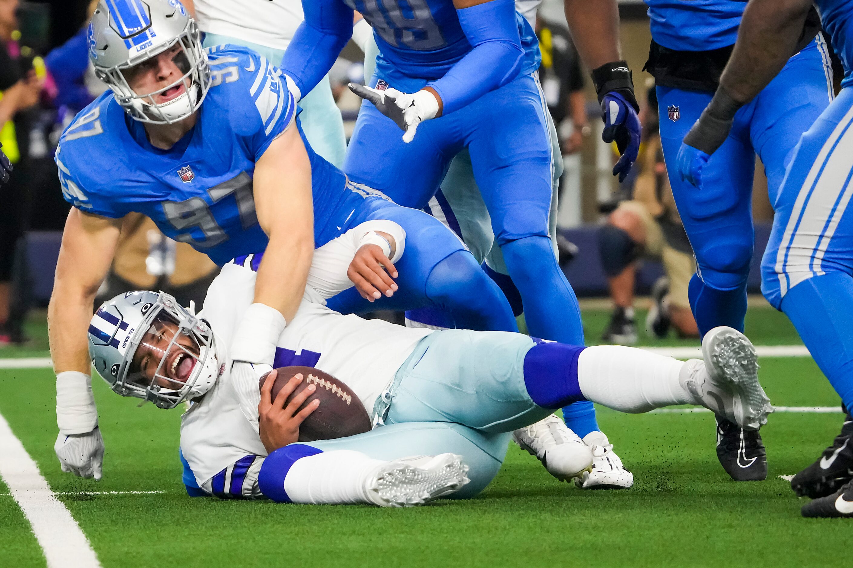 Dallas Cowboys quarterback Dak Prescott (4) is sacked by Detroit Lions defensive end Aidan...