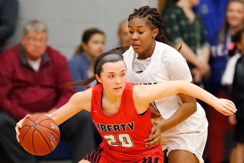 Frisco Liberty's Mara Casey (20) is defended by Frisco Lone Star's Kayla Richardson (30)...