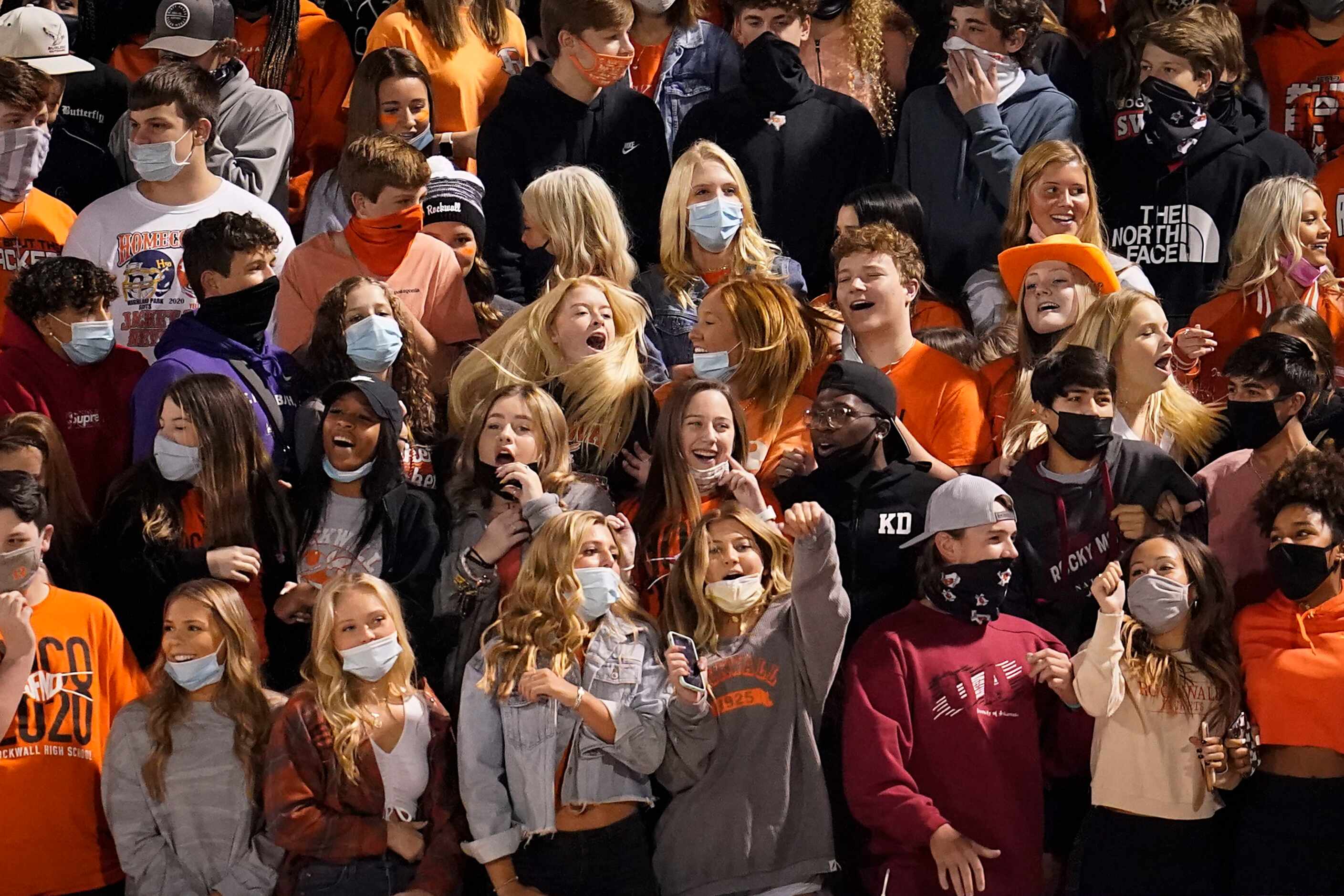 Rockwall students cheer as their team takes the field before a high school football game...