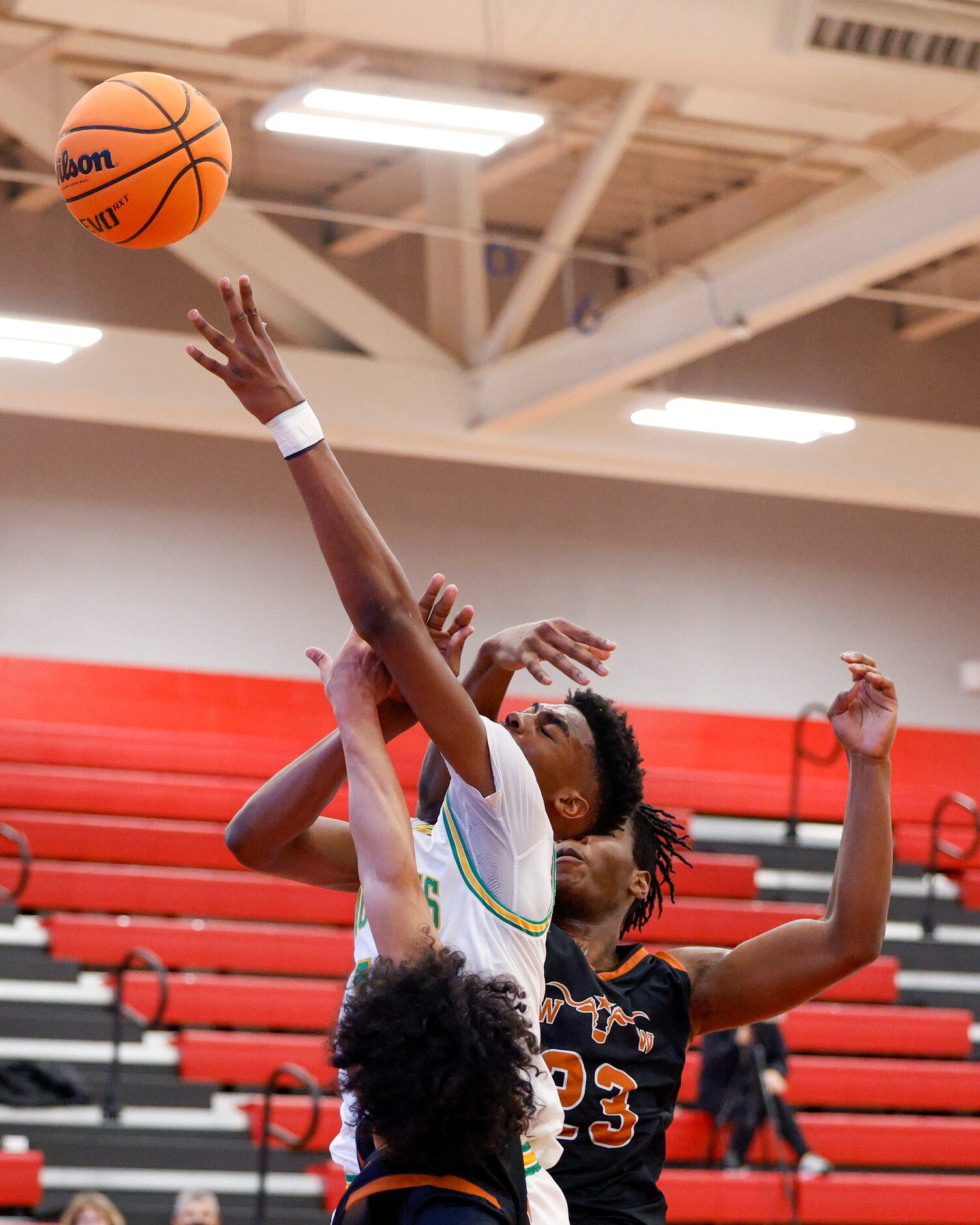 W.T. White forward PJ Washington (23) fouls Madison forward Quintin Spencer (13) on a shot...