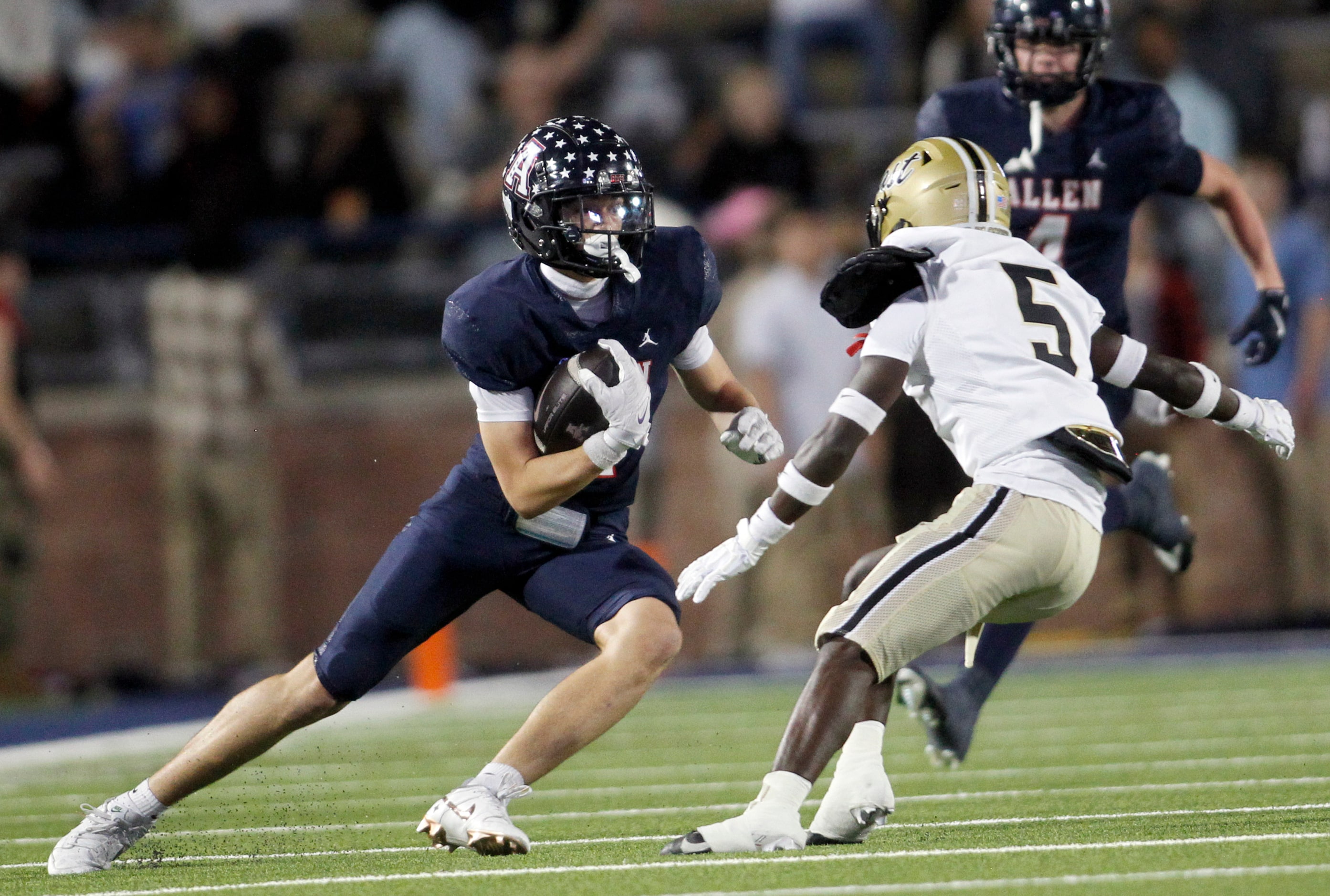 Allen receiver Carter Harris (14), left, makes a cut to avoid the pursuit of Plano East...