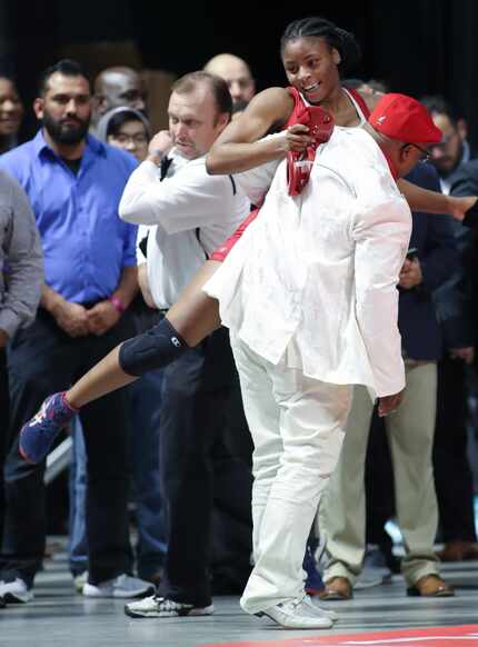 Miles embraces coach Devon Fortson after she won the UIL Class 5A girls 148-pound...