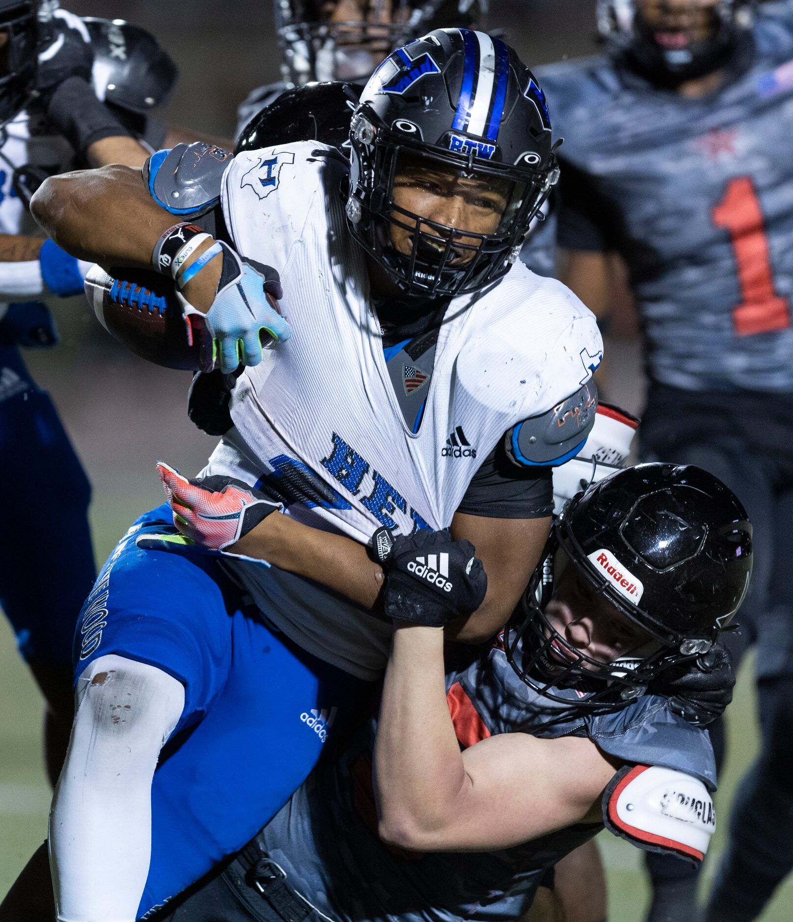 Hebron senior running back Bryson Spriggs, left, is tackled by Coppell junior linebacker...