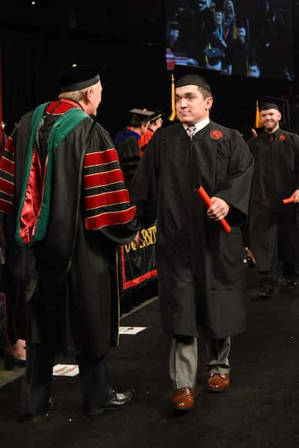 Ryan Dant receives his diploma at the University of Louisville graduation ceremony on May...