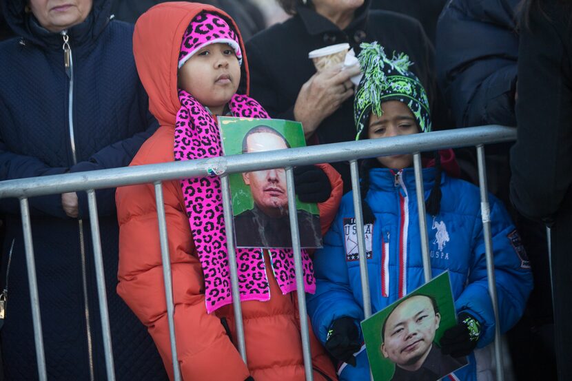 NEW YORK, NY - DECEMBER 26: Children hold signs outside the wake for New York City police...