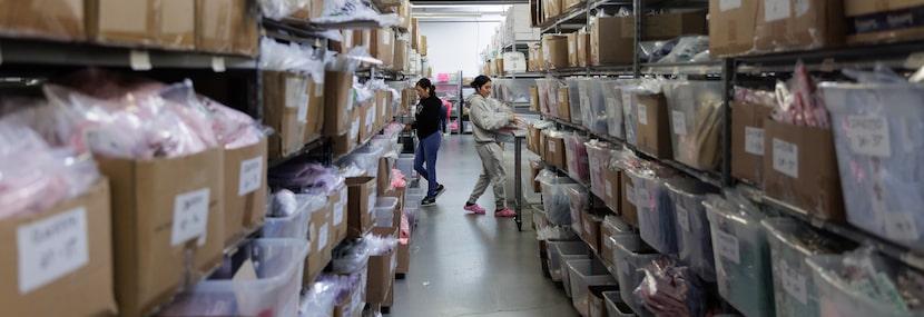 Thelma Pena (left) and Patricia Ramirez work in the shipping department at Classic Whimsy in...