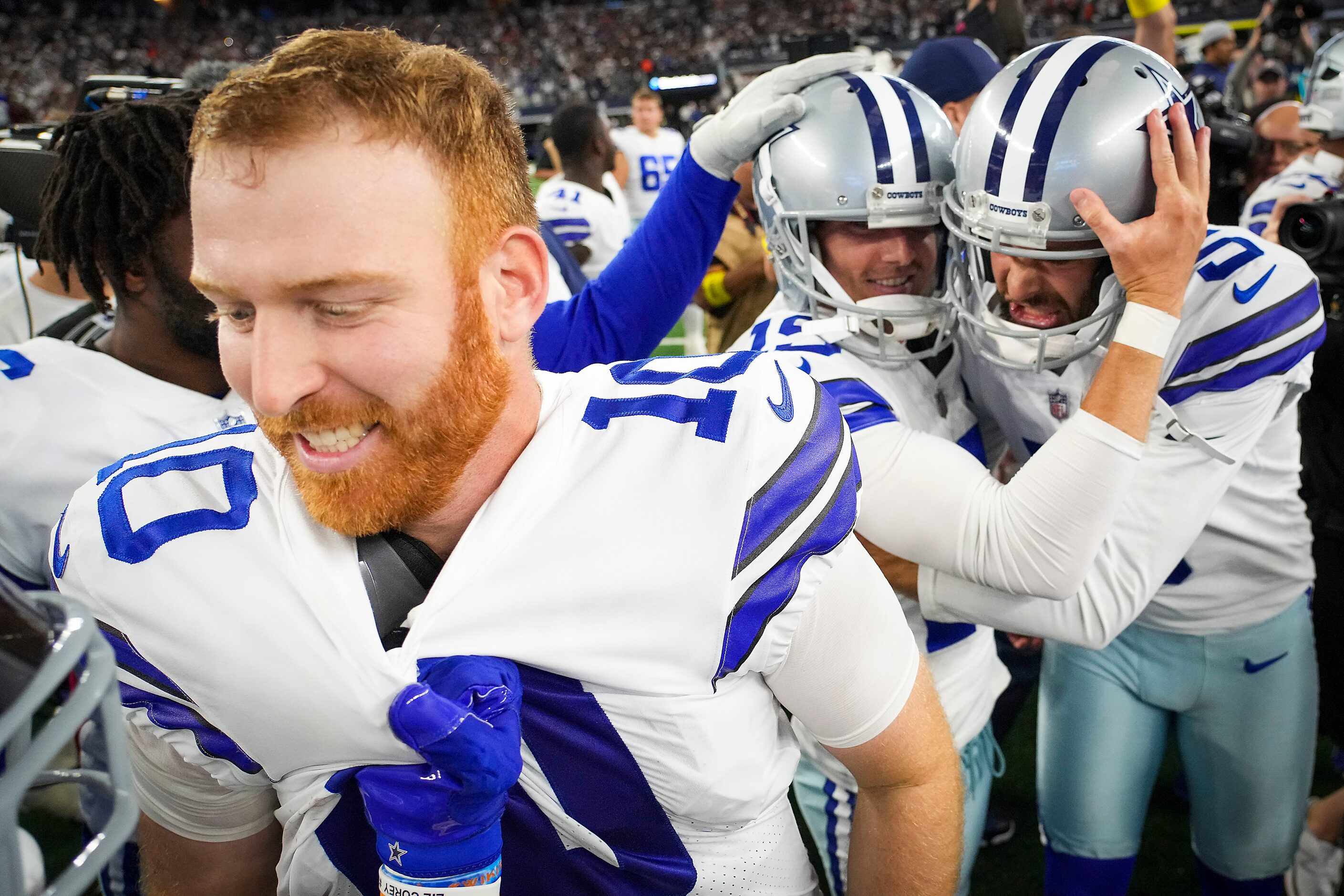 Dallas Cowboys quarterback Cooper Rush (10) is grabbed on the shirt by running back Ezekiel...