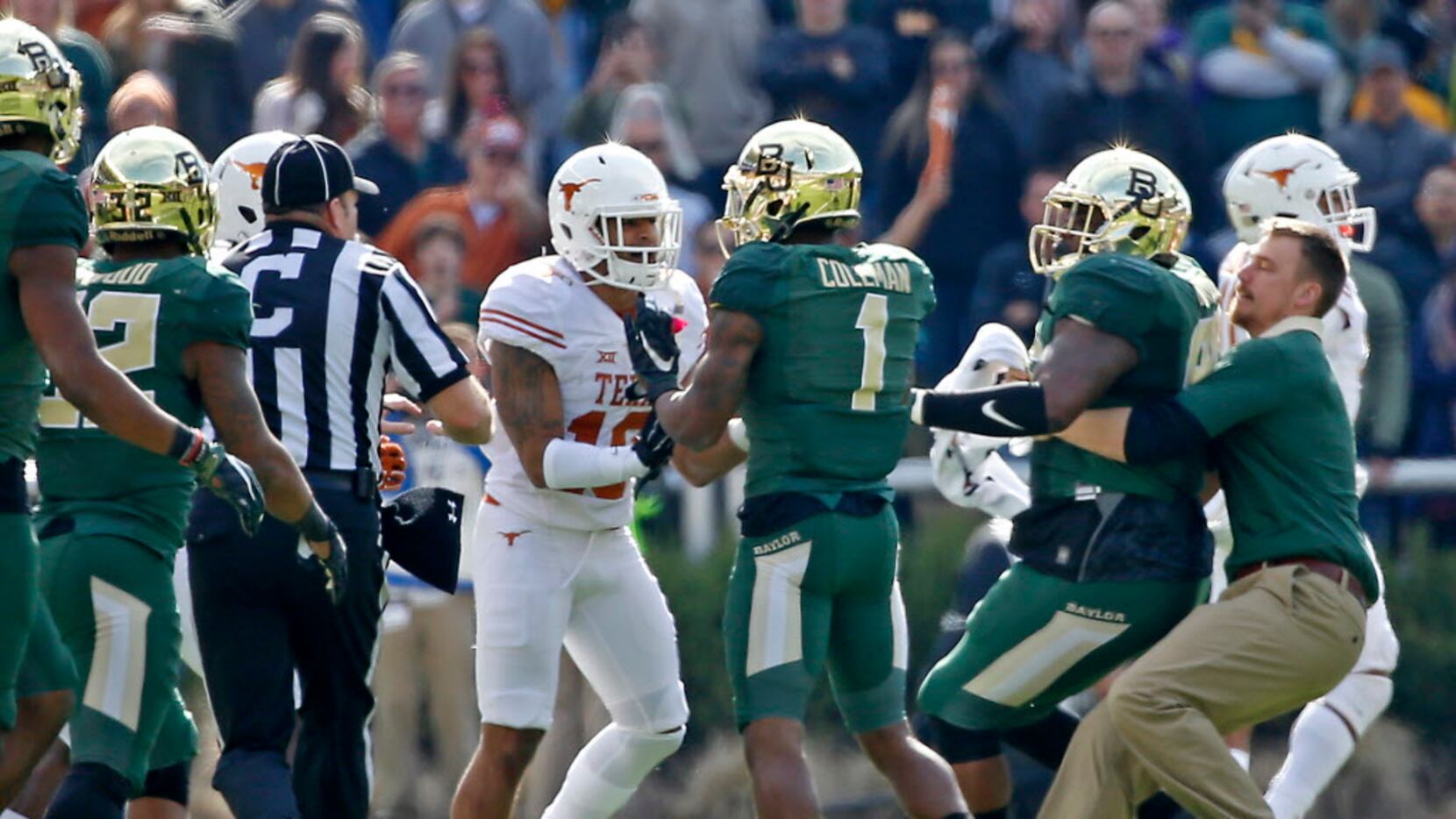 Baylor wide receiver Corey Coleman (1) and Texas safety Kevin Vaccaro (18) square off during...