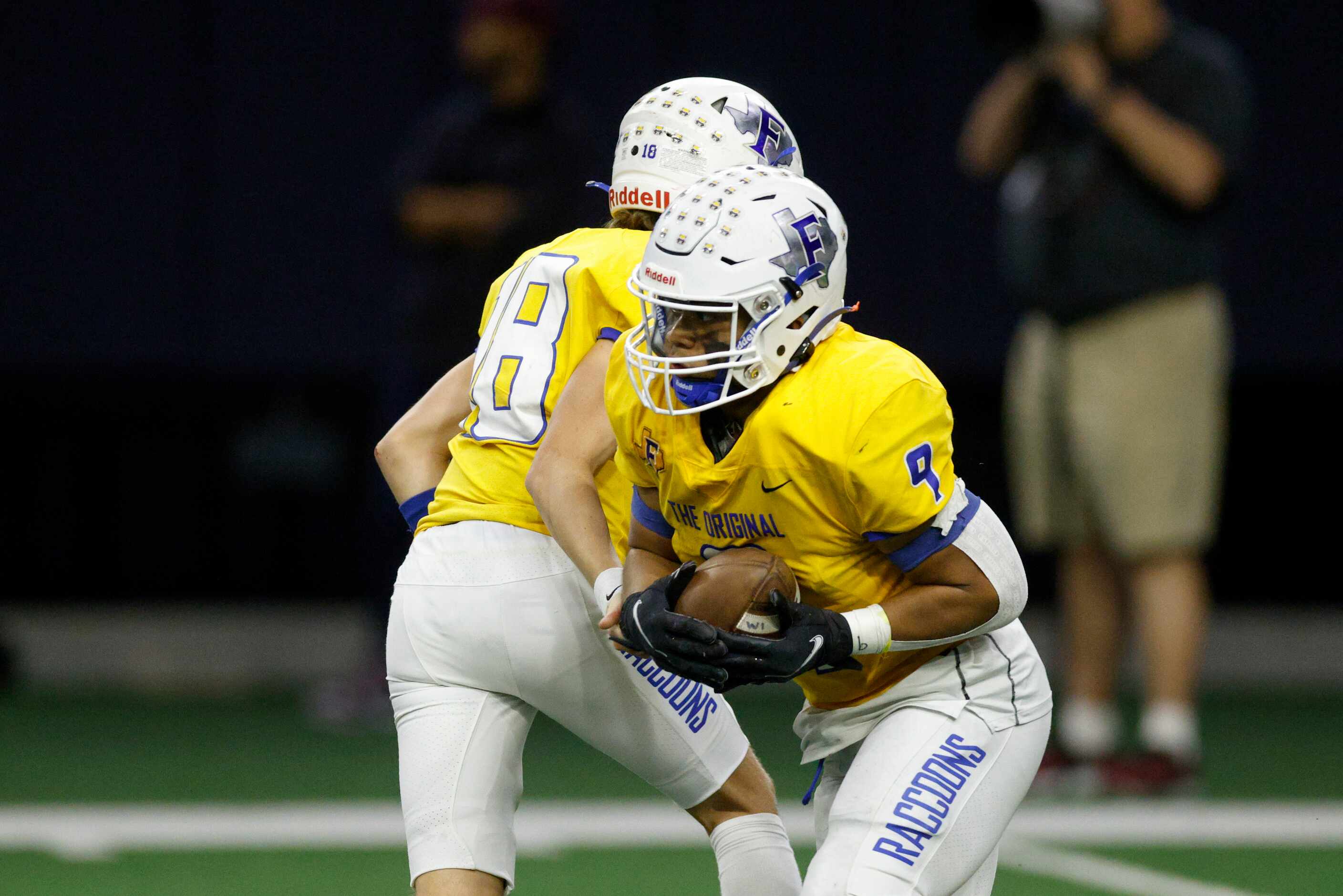 Frisco quarterback Camren Gibson (18) hands the ball to running back Keane Ramos (9) during...