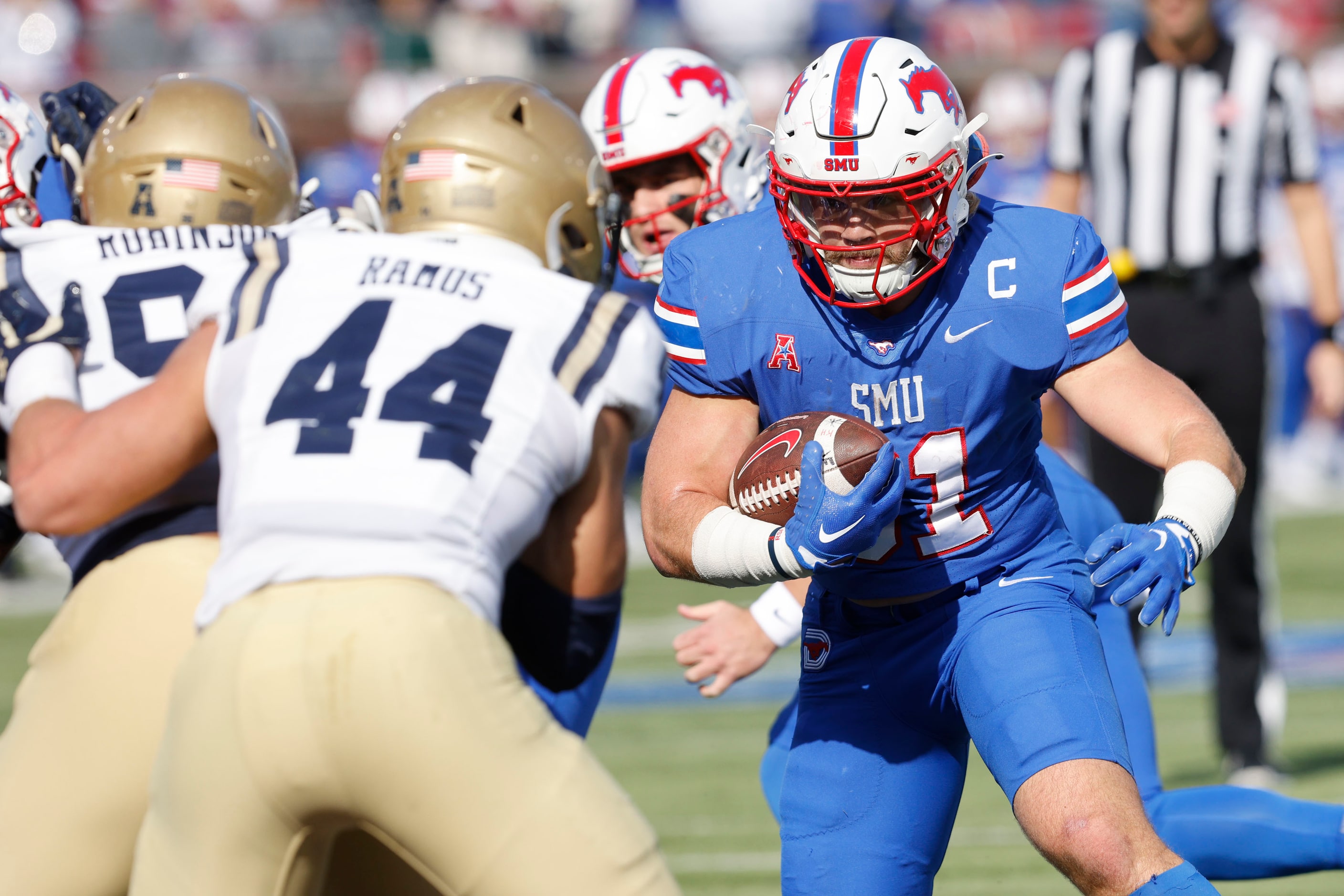 SMU running back Tyler Lavine (31) scores a touchdown passing Navy linebacker Colin Ramos...