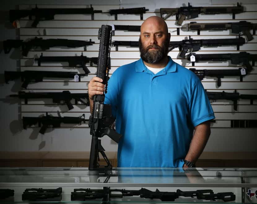 Ro Carter, owner of Mister Guns shop, poses for a photo with a Keystone made Ripsaw AR-15 in...