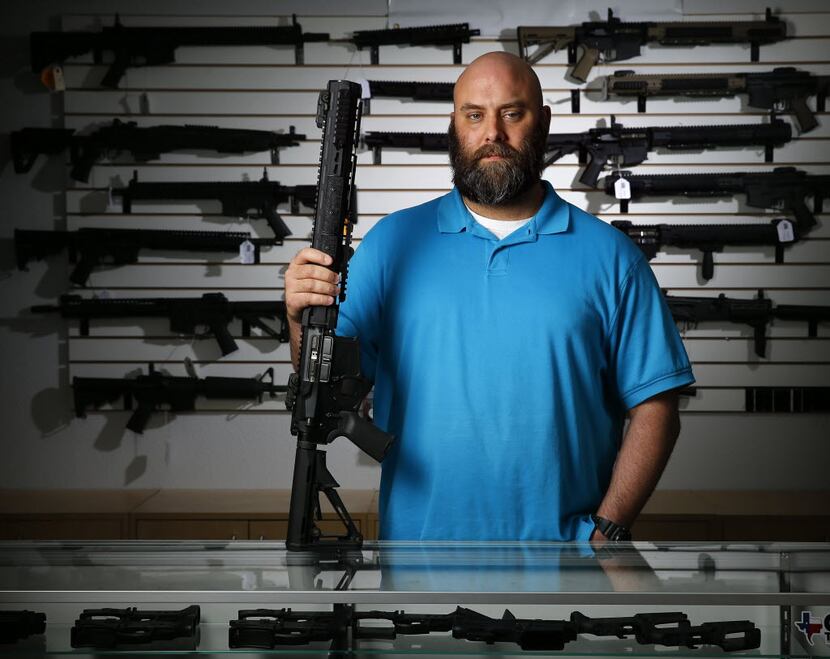 Ro Carter, owner of Mister Guns shop, poses for a photo with a Keystone made Ripsaw AR-15 in...