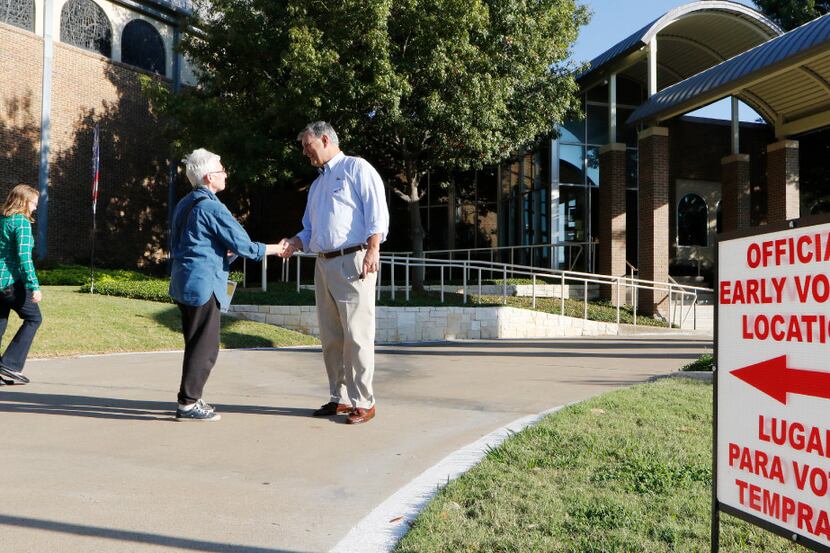 Dallas Mayor Mike Rawlings greets voters before he voted early at Our Redeemer Lutheran...