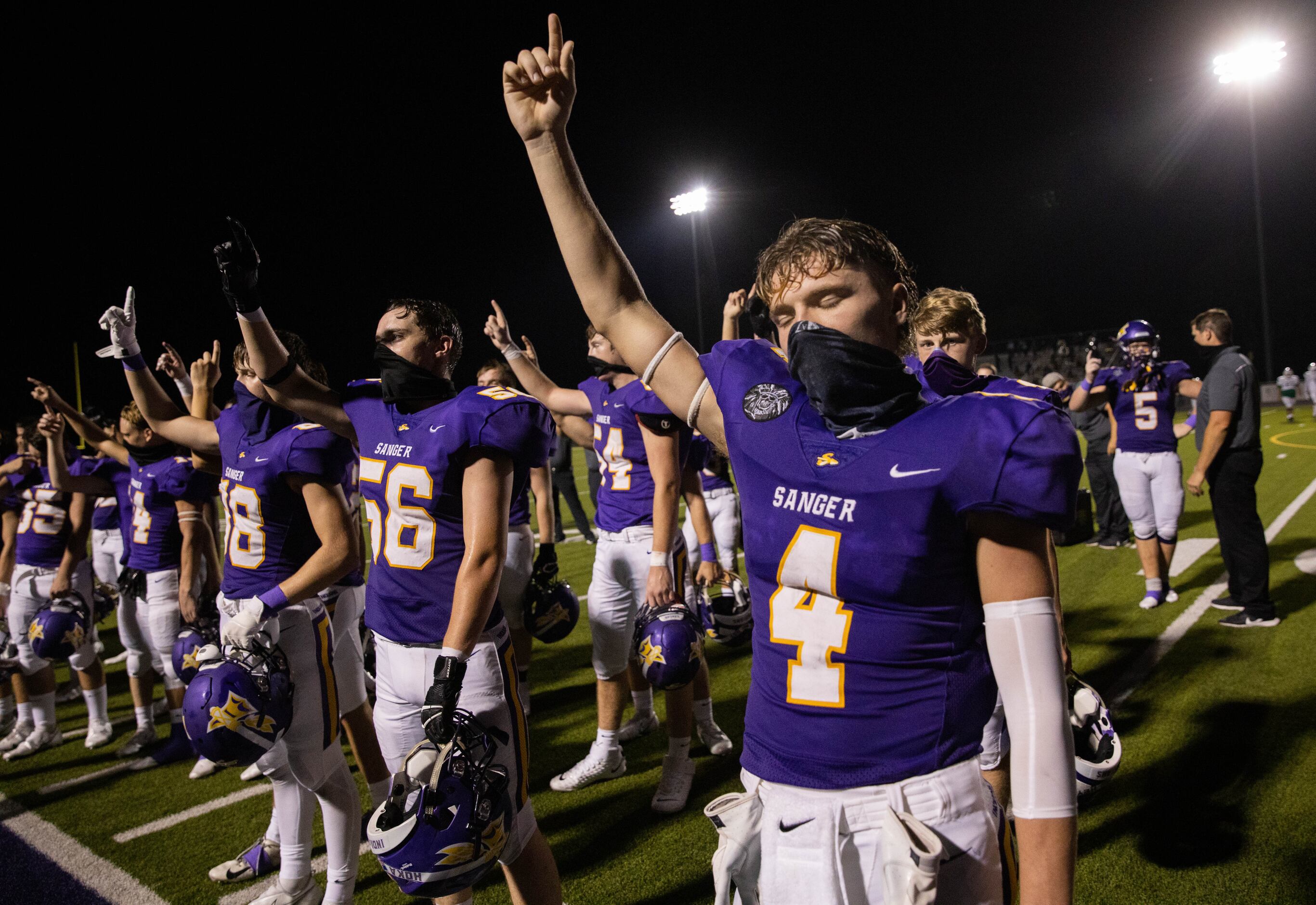 Sanger High School player Avery Walker (4) celebrates with his team after winning against...