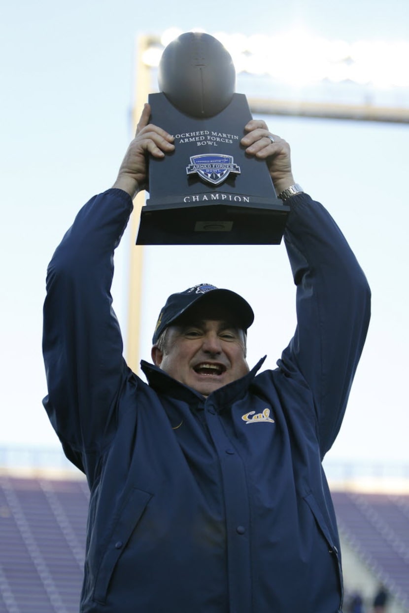 California Golden Bears head coach Sonny Dykes holds up the Lockheed Martin Armed Forces...