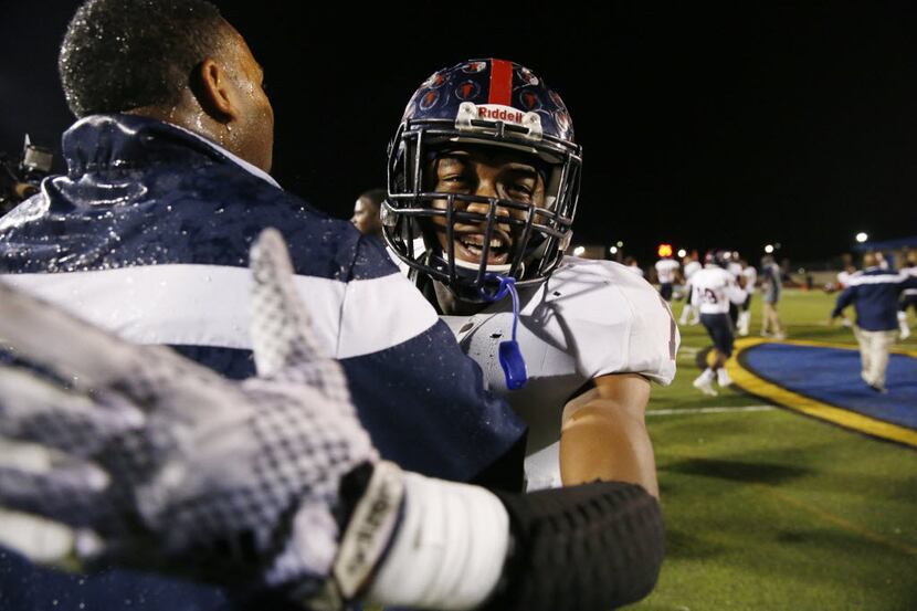 Bishop Dunne defensive back Chevin Calloway (1) celebrates with head coach Michael Johnson...