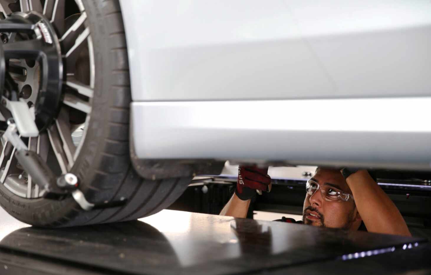 Service technician Adrian Ventura works on a Porsche at Porsche Grapevine. Park Place...