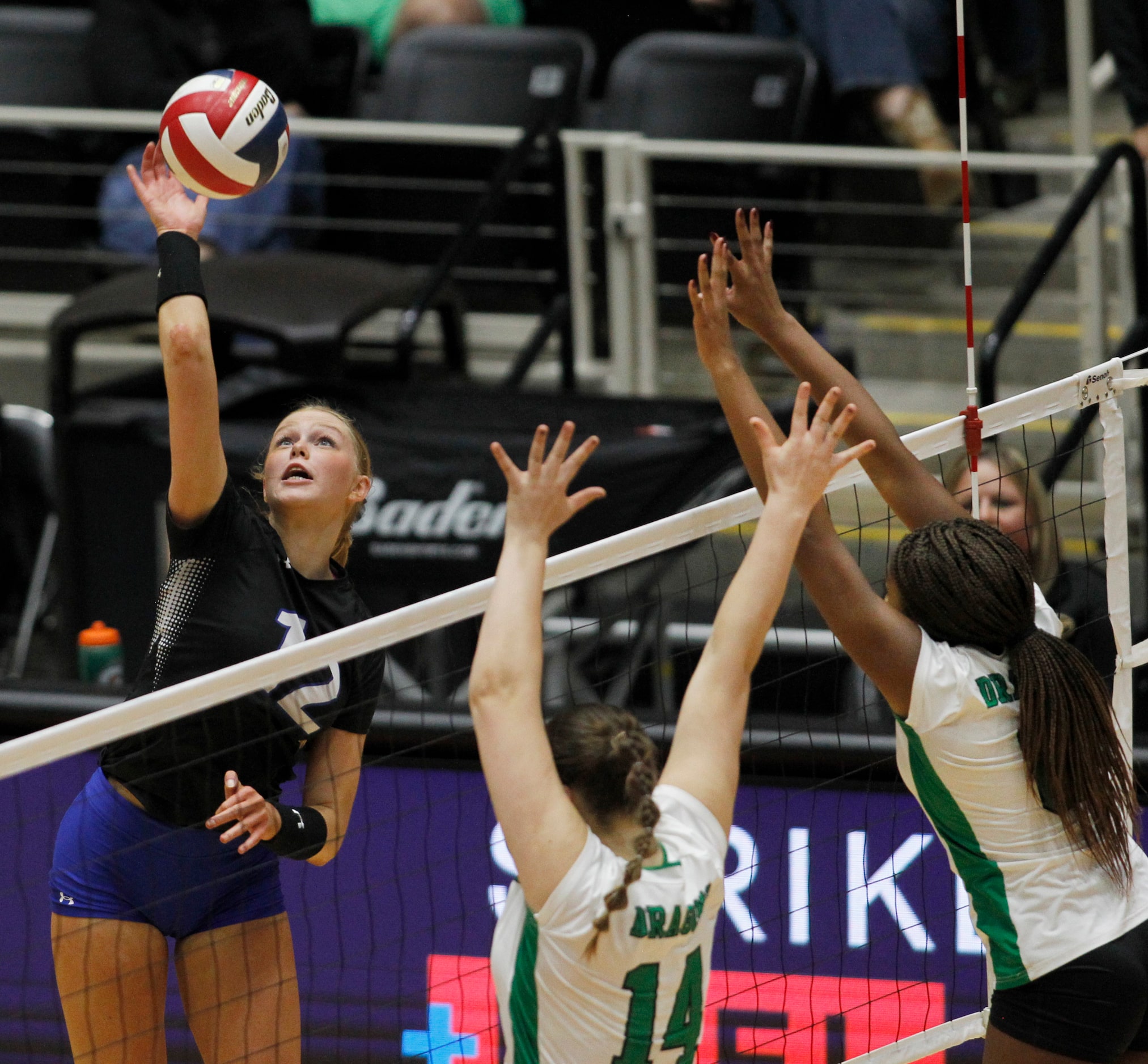 Byron Nelson outside hitter Ashlyn Seay (12), left, fires a shot into the defense of...