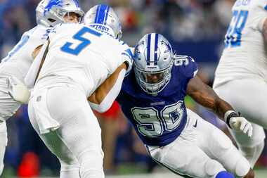 Dallas Cowboys defensive end DeMarcus Lawrence (90) tackles Detroit Lions running back David...