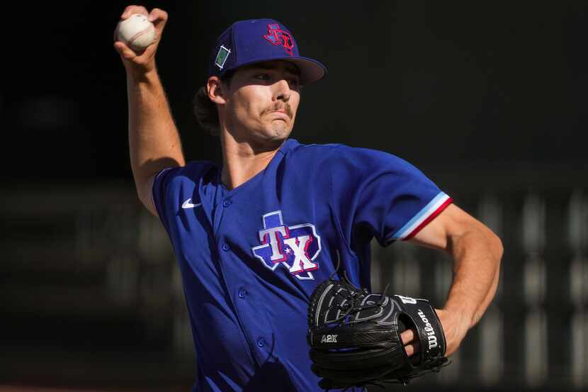 Texas Rangers pitcher Cole Winn delivers during the sixth inning of a spring training game...