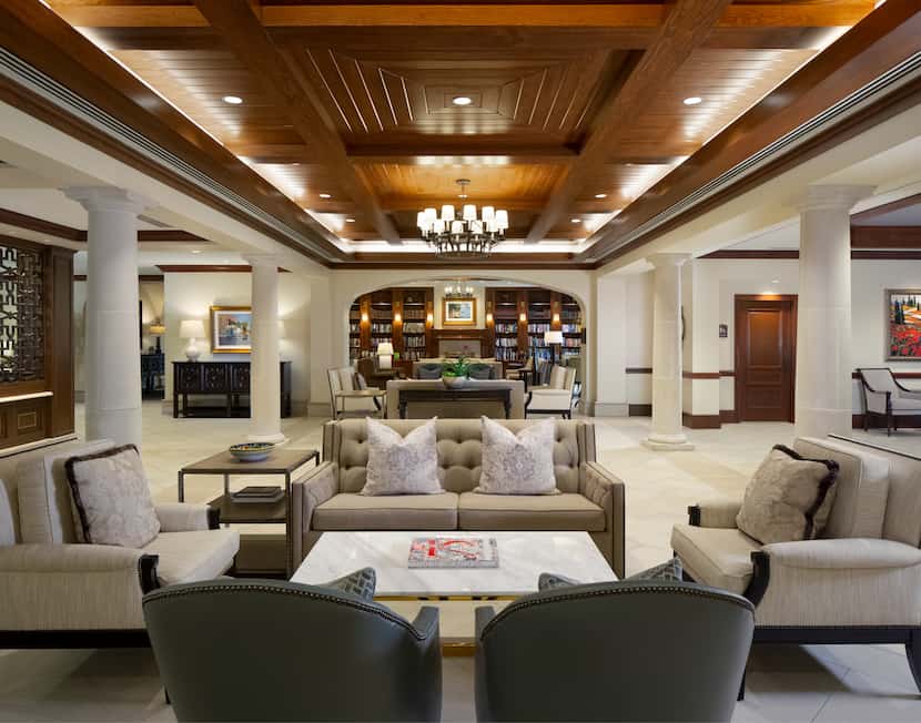 Elegant, spacious lobby with sitting area consisting of loveseat and chairs around a low...