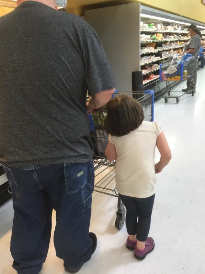 A young girl is pulled by her hair at a Wal-Mart in Cleveland, Texas. (Erika Burch)