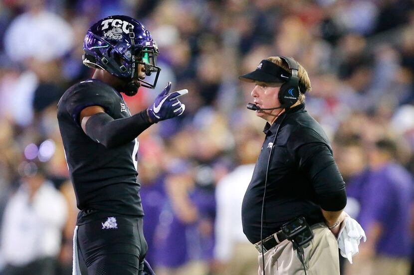 TCU Horned Frogs head coach Gary Patterson visits with a player during a first half timeout...