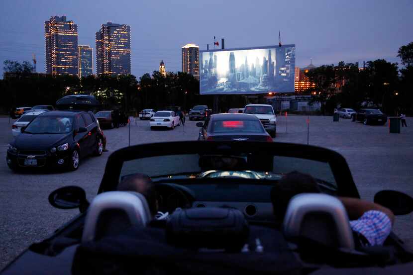 People watch the previews before the show while they visit the Coyote Drive-In in Fort...