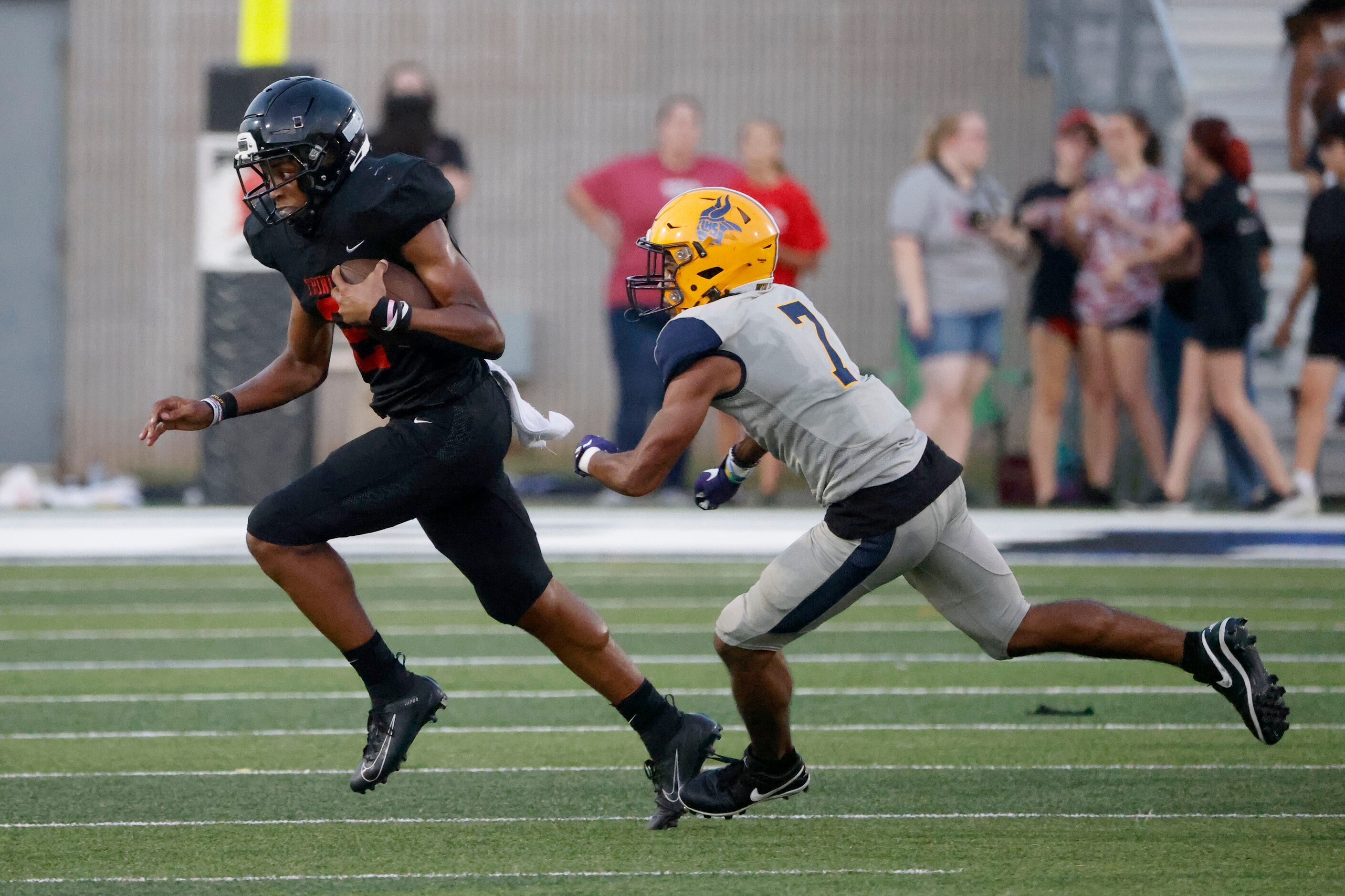 Trinity quarterback  Ollie Gordon (2) runs away from Arlington Lamar defender Lonnell ...