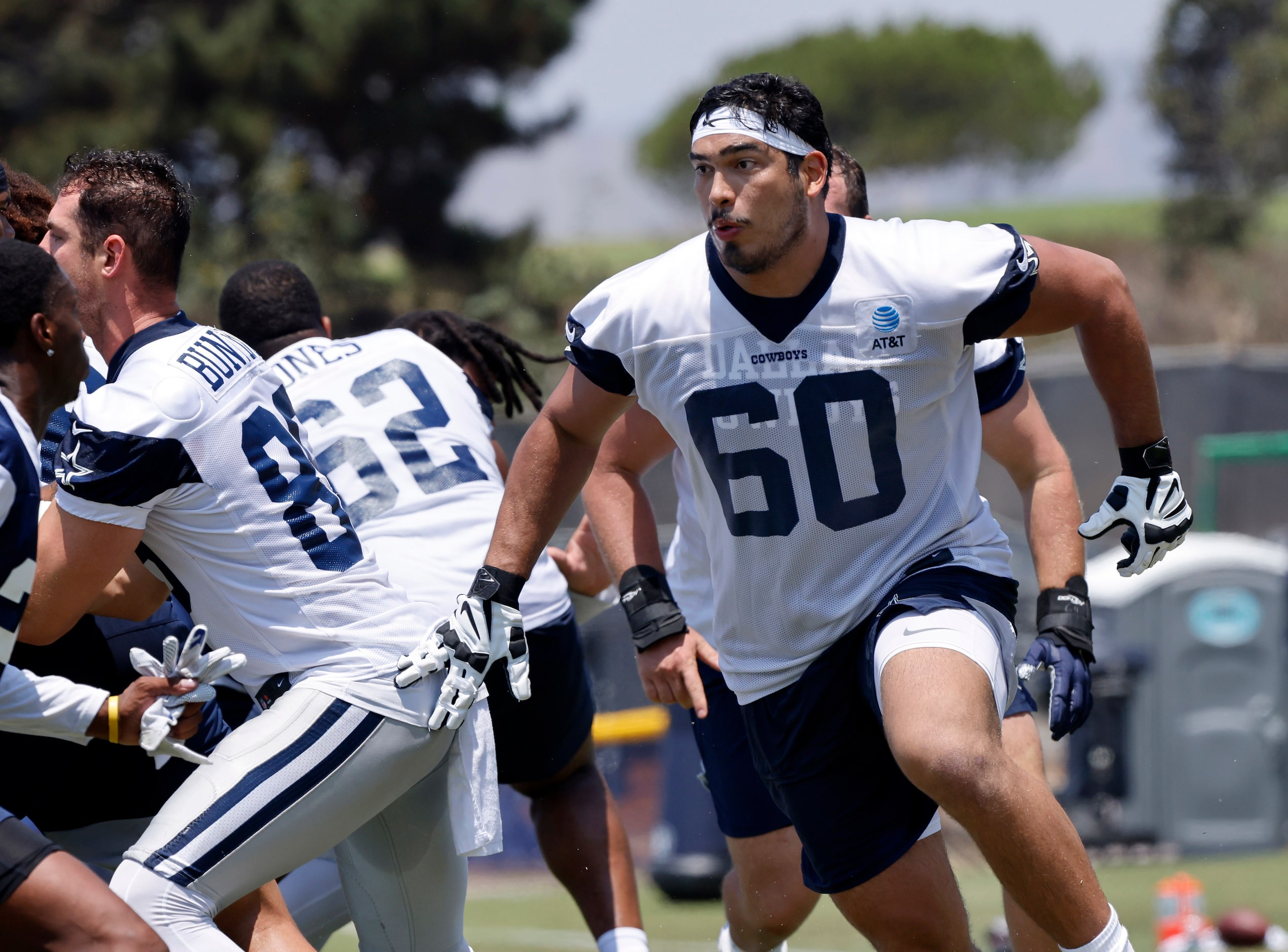 Dallas Cowboys offensive tackle Isaac Alarcon (60) pulls around the end as they run a play...