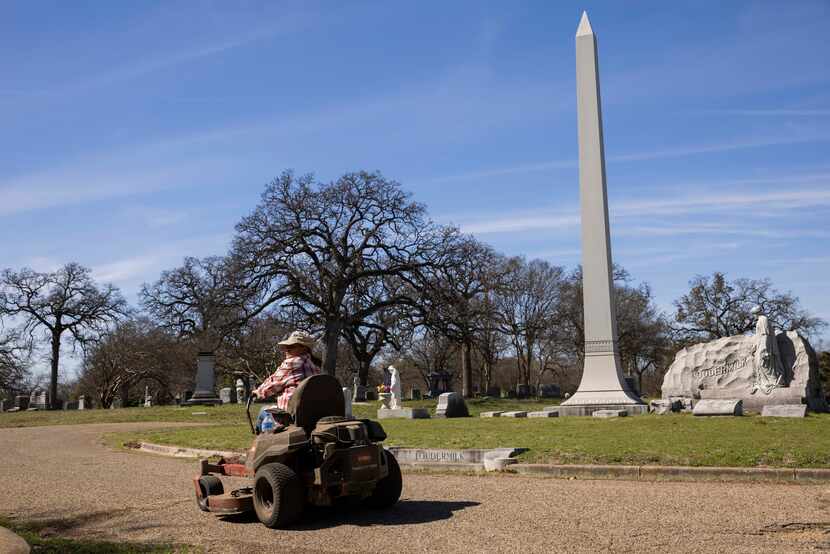 Monica Newbury, who had spent five hours mowing Tuesday, prepares to put the lawn mower away...