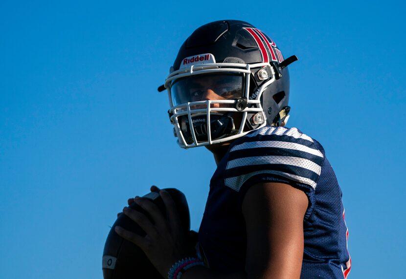 Quarterback Grayson James (3) throws a pass as the John Paul II High School football team...