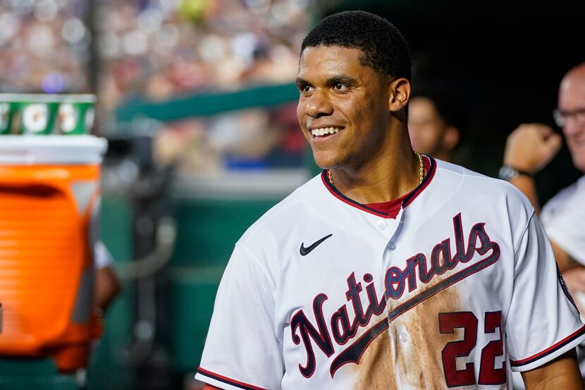 FILE - Washington Nationals' Juan Soto smiles in the dugout after a solo home run during a...