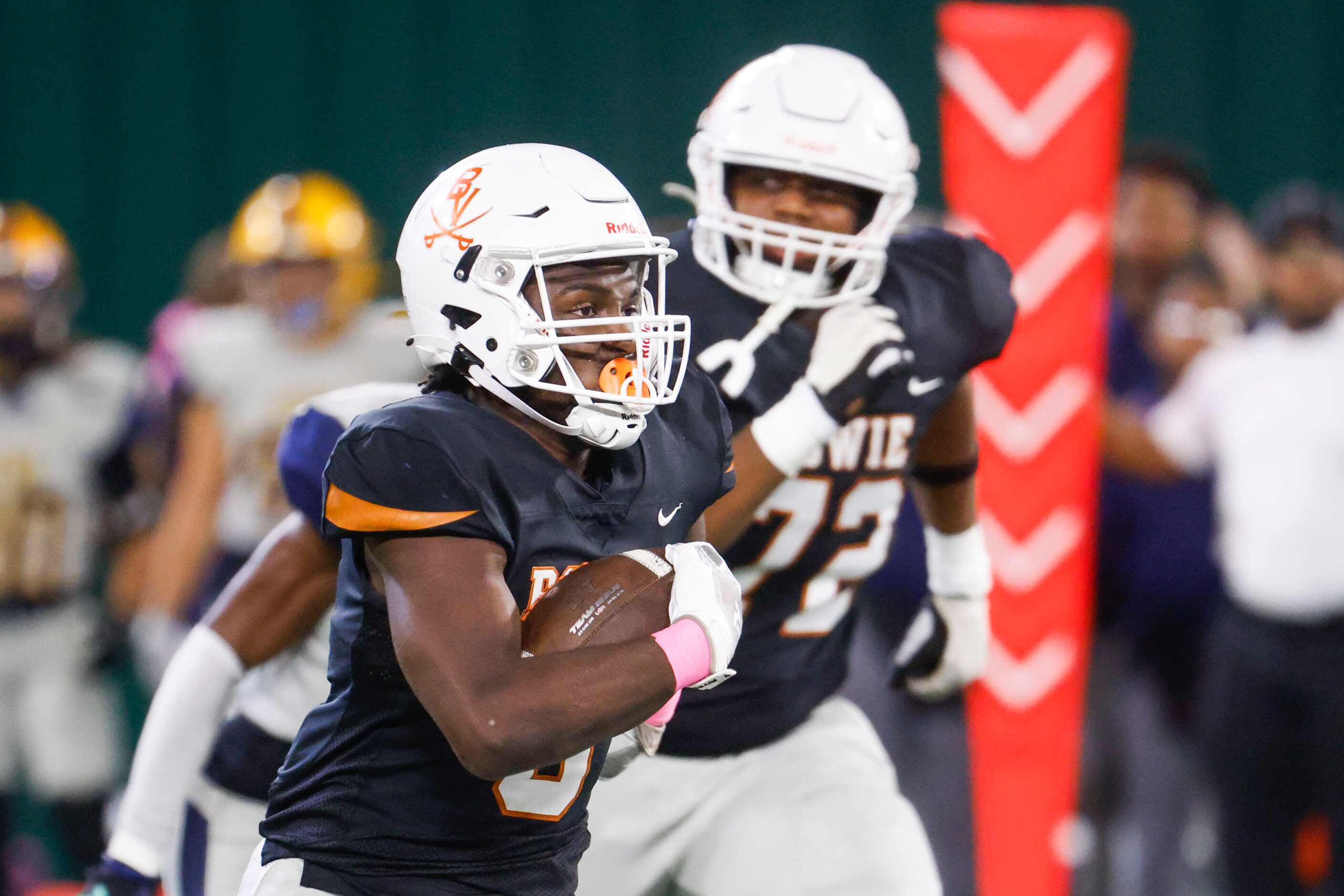 James Bowie High’s Darrion Bowers (front) runs for a touchdown during the first half of a...