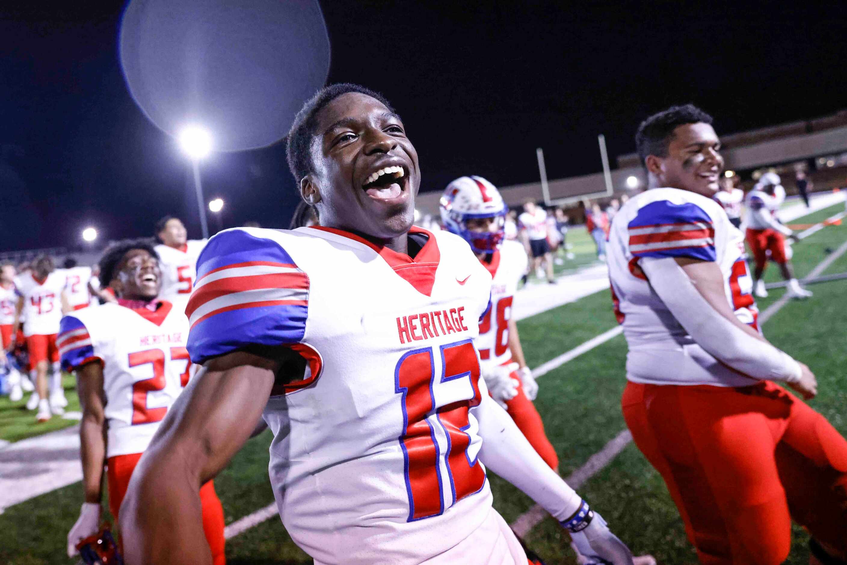 Midlothian Heritage high players including John Olusanya (12) celebrate after winning the...