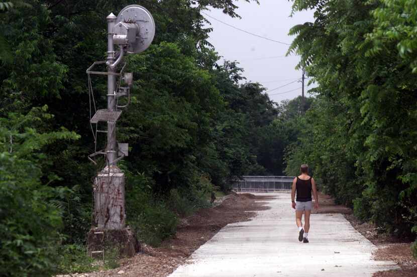 The old Katy railroad tracks were turned into an urban bike/hike trail. In this photo near...