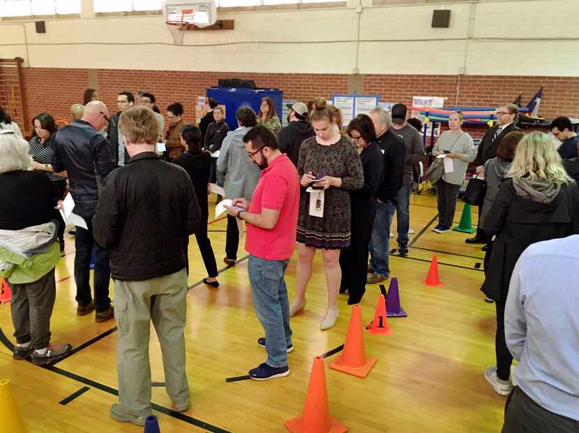 Voters in the Super Tuesday Democratic and Republican primaries lined up while waiting to...