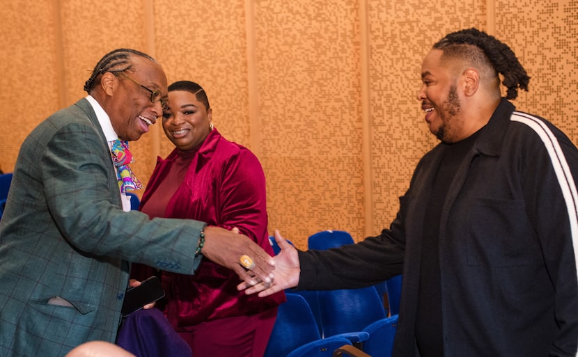 Dallas County Commisioner John Wiley Price (left) shakes hands with filmmaker Darius Clark...