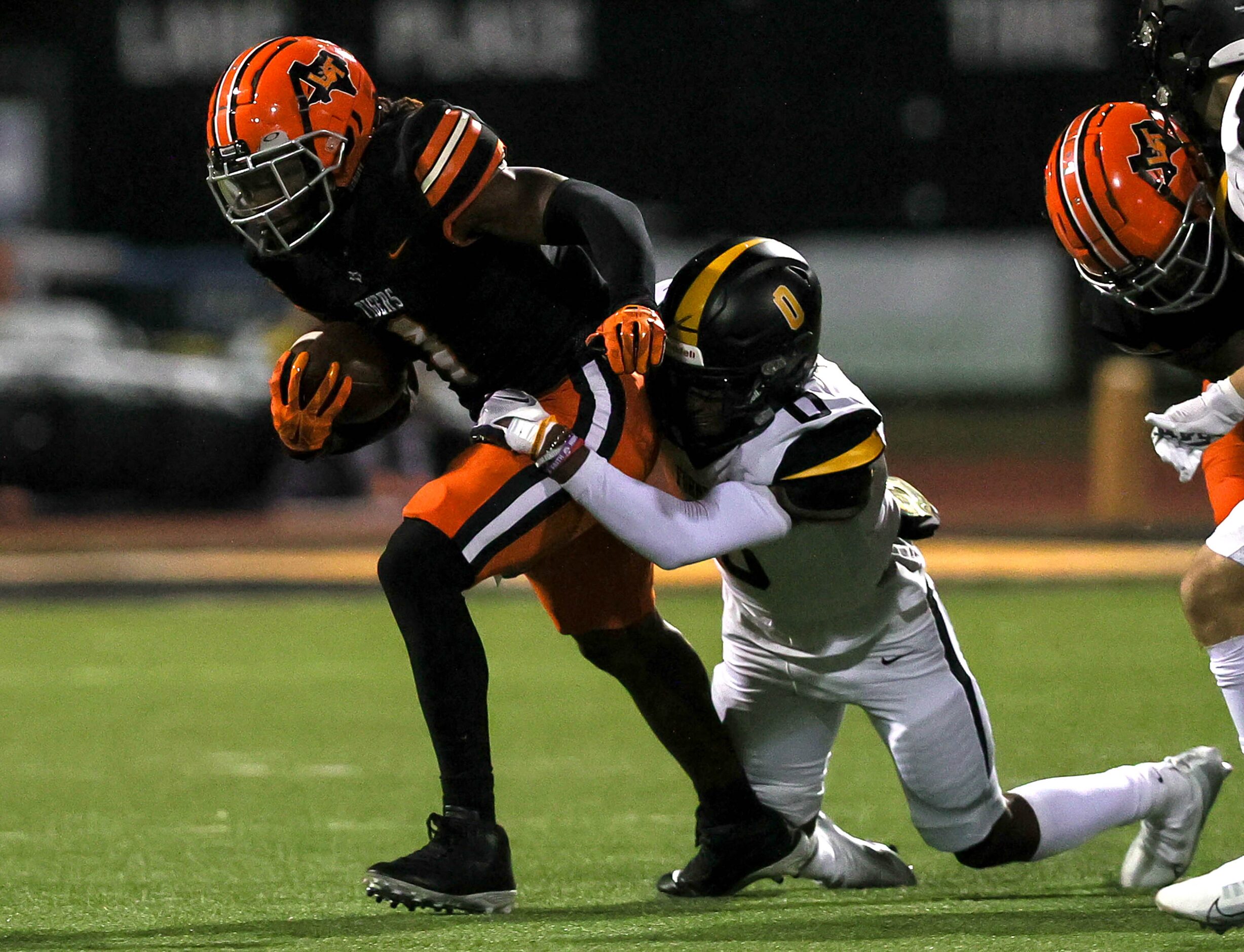 Lancaster running back Kyson Brown (1) drags Forney linebacker Ky Kennedy (0) for a nice...