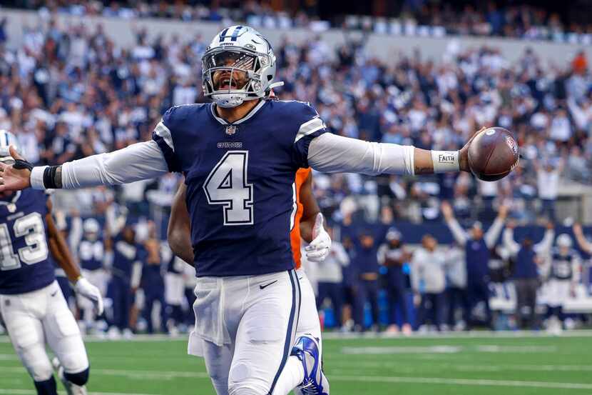 Dallas Cowboys quarterback Dak Prescott (4) celebrates after a seven yard touchdown run...